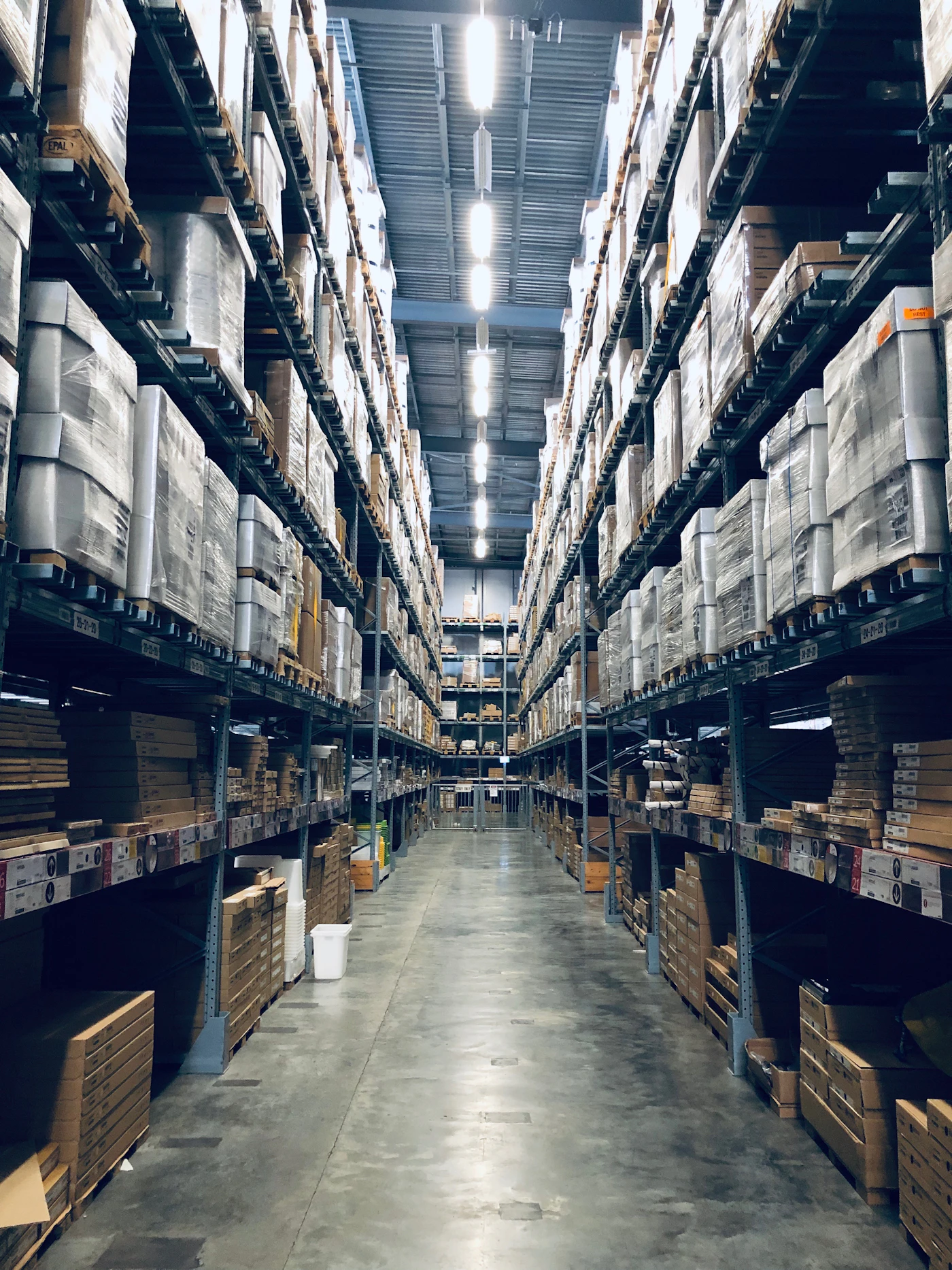 Surplus commercial stock on warehouse shelving — the type of redundant inventory East Anglia Asset Partners purchases across Suffolk, Norfolk, Essex and Cambridgeshire